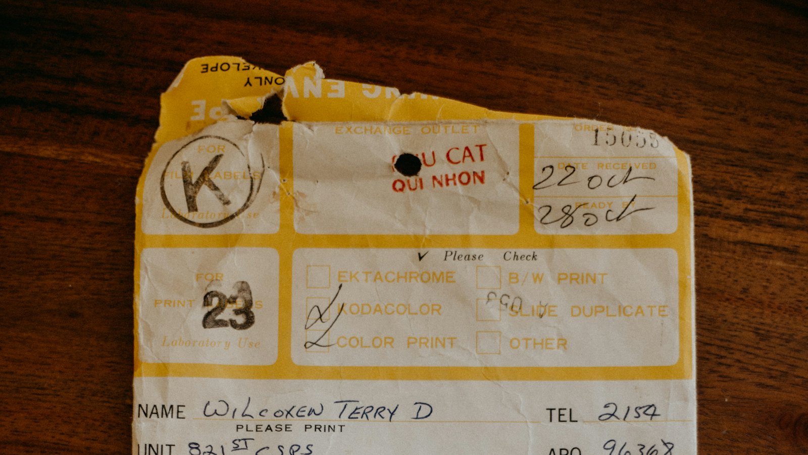 A handwritten order form on a wooden table