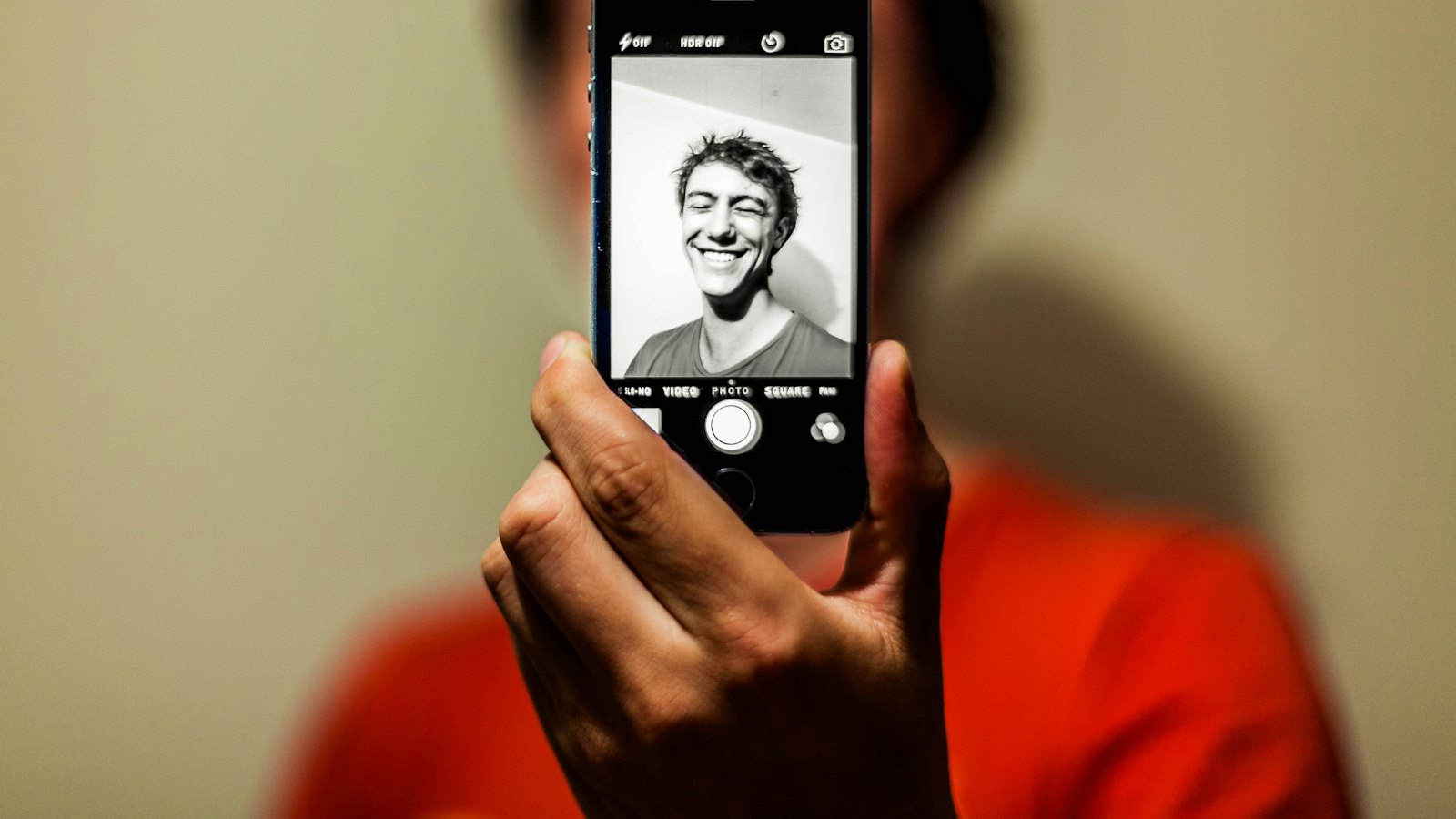 A person taking a selfie with a smartphone
