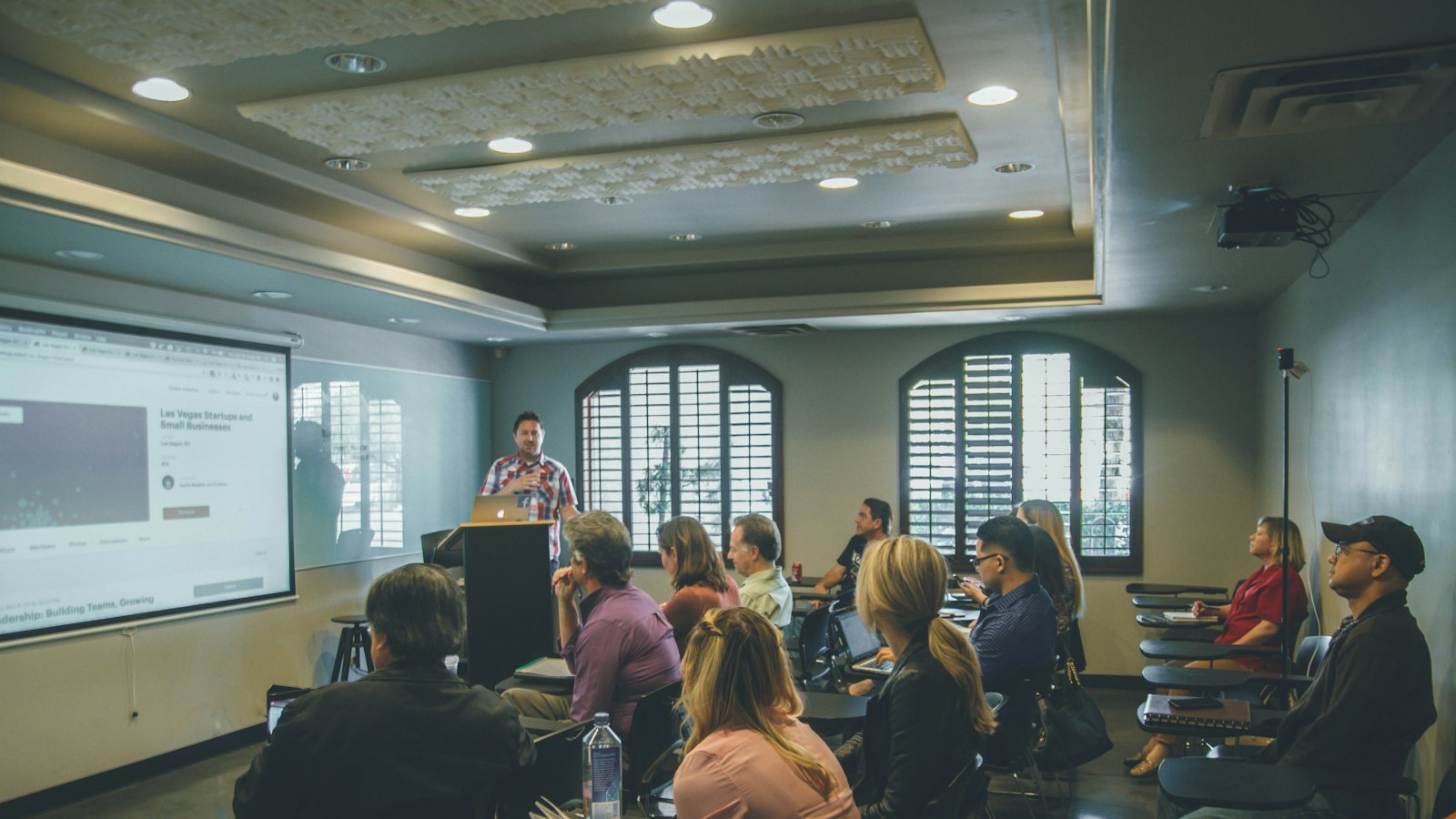 A training session with a presenter and a projector screen