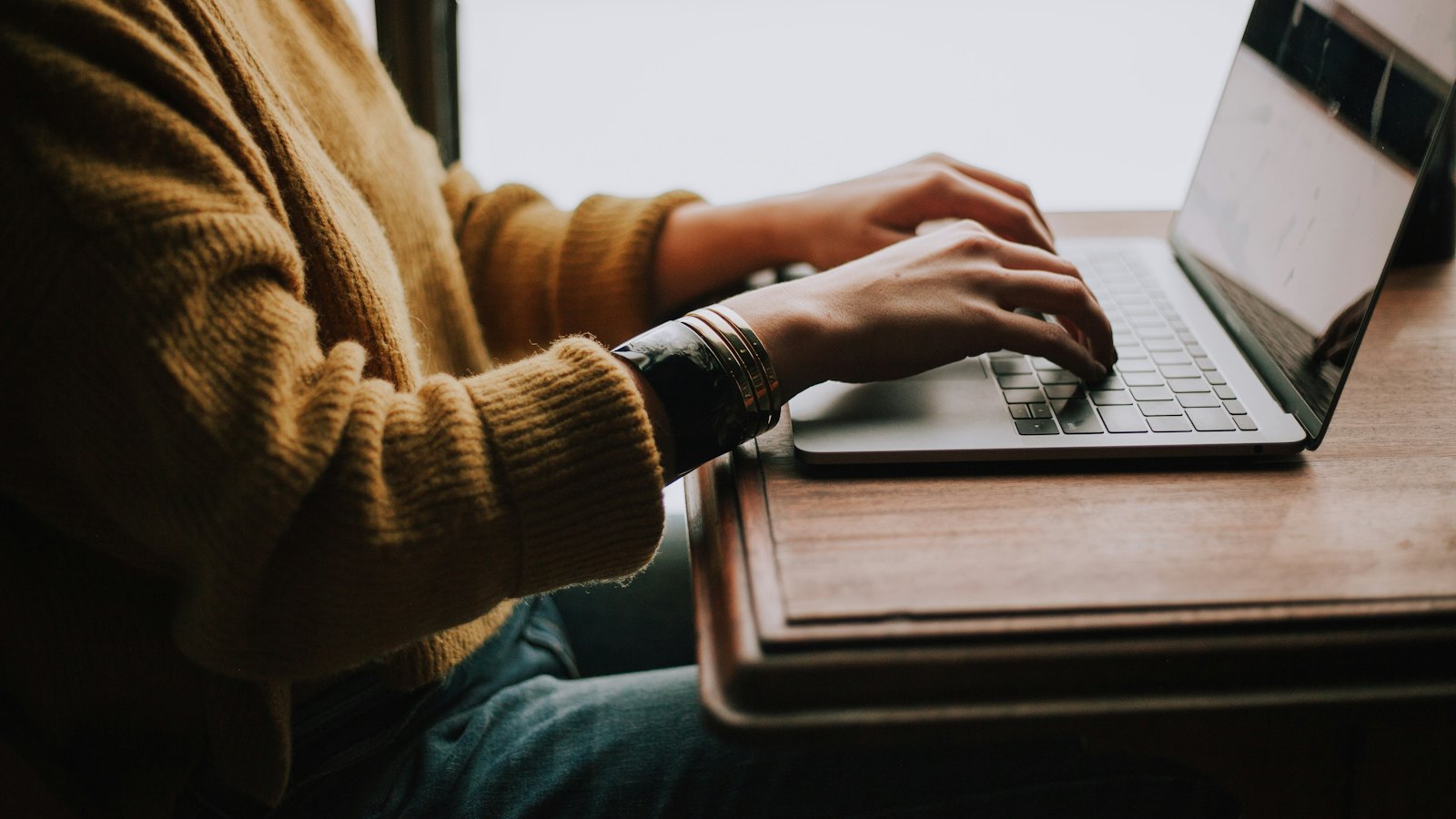 A person working on a laptop at home