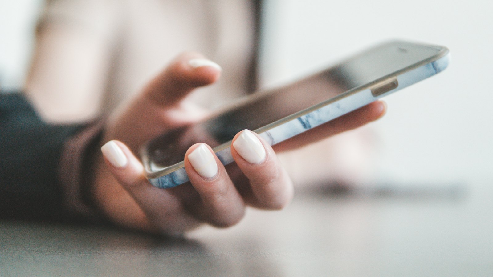 A hand holding a smartphone