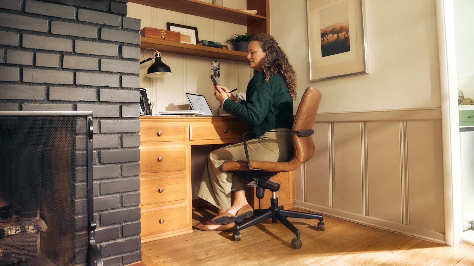 A woman working at a desk in a home office